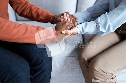 Image of Holding hands, black couple and therapy help on sofa for support, solidarity and listening for love in relationship. Man, woman and couch for helping hand at psychology, consultation or trust problem