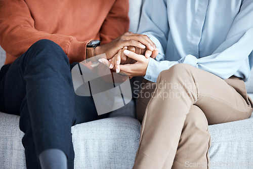 Image of Holding hands, couple and psychology help on sofa for support, solidarity or love for growth in relationship. Black people, couch or helping hand at therapy consultation for problem, fight or anxiety