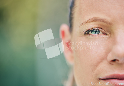 Image of Half, face and portrait of a woman at tennis with vision, motivation and serious about a game. Mockup, focus and sports player looking serious while playing sport on a court and bokeh background