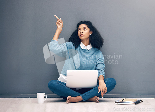 Image of Laptop, thinking and pointing with black woman on floor with mockup for social media, news and presentation. Offer, online shopping and technology with girl for communication, internet or advertising