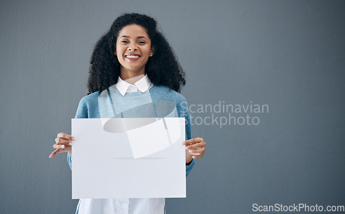 Image of Mockup, portrait and black woman with poster for space, advertising sign and branding on grey background. Face, blank or billboard by girl relax on mock up, copy or announcement on product placement