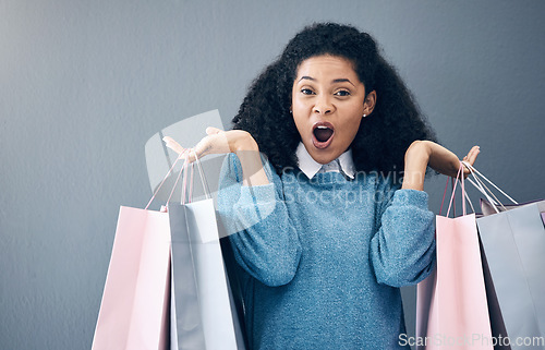 Image of Wow, discount and portrait of woman with shopping bags, retail therapy and surprise at sale on wall. Deal, excited and happy girl holding products from a shop, market or mall on a background