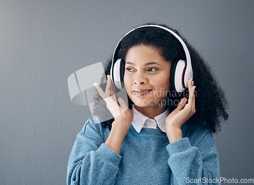 Image of Music, relax and black woman in studio with peace, streaming or good mood on grey background. Radio, podcast and girl with positive, mindset or audio, online or playlist on advertising isolated space