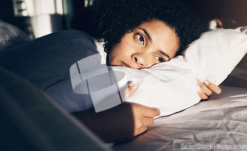 Image of Anxiety, depression and sad woman tired in bed with insomnia, thinking and trying to sleep while sick. Morning, sunrise and depressed girl with stress, mental health problem and fatigue in bedroom