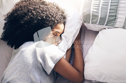 Image of Sleeping, bedroom and relax with a black woman in bed, dreaming or resting in the morning at home. Sleep, tired and rest with an attractive young female asleep in her house over the weekend