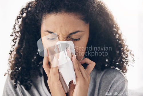 Image of Black woman, tissue and sneeze of a sick young person blowing nose with toilet paper for safety. Flu, fever and cold of a female feeling tired from sirus infection at home with a health problem