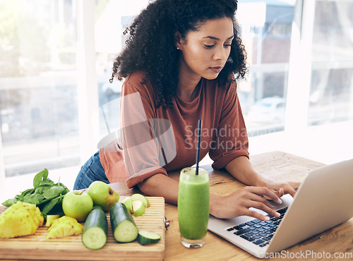 Image of Research, smoothie and health with black woman and laptop for blog, salad and vegetables. Nutritionist, diet and food with girl by kitchen counter for cooking, technology and learning at home
