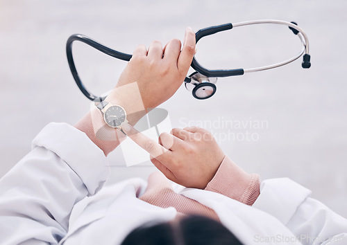 Image of Top view, hands or doctor checking watch in hospital schedule, late appointment or medical biometrics. Woman, stethoscope or clock time in healthcare wellness visit, annual consulting or clinic visit