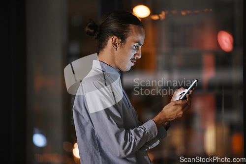 Image of Phone, night and communication with a business man in his office, working late to make a global deadline. Mobile, contact and networking with a male employee at work using a smartphone app to email