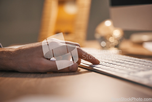 Image of Hands, keyboard and typing at night for digital planning, strategy or online research at office desk. Closeup hand of person or employee working overtime on computer at desktop for project deadline