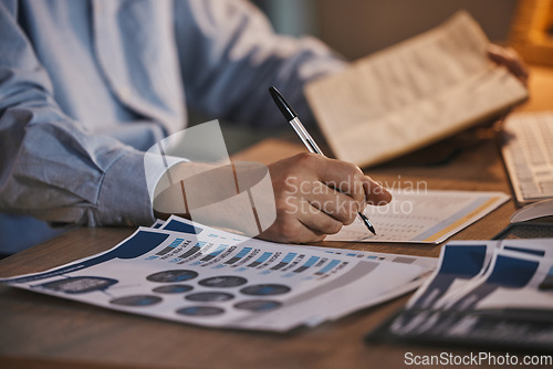 Image of Business man, writing and data analytics with documents or paperwork with finance information. Hand of person at desk for research, trading and stock market infographic paper for planning or analysis