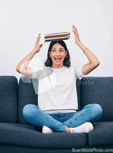 Image of Student or woman with books balance on head for study, education or university time management and reading. Knowledge, learning and young college person on sofa with history, philosophy or literature