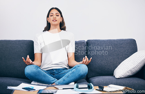 Image of Study, meditation and Indian woman in a living room with zen to relax from book learning. Sofa, home and female student meditate on a couch doing yoga for wellness in a house with education notebook