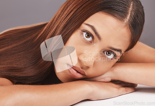 Image of Portrait, skincare and hair with a model black woman in studio on a gray background for keratin treatment. Face, beauty or haircare with an attractive young female indoor to promote a natural product