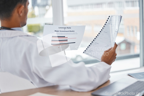 Image of Doctor or man reading medical documents relax in office for surgery, medicine or healthcare charts for feedback. Paper, research or nurse with insurance, hospital contract or health report review