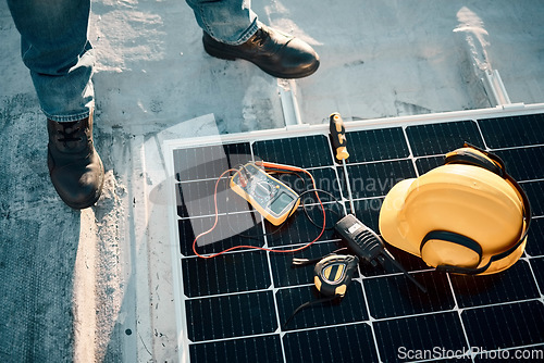 Image of Solar panel maintenance, tools and outdoor with engineer feet, helmet or renewable energy vision in top view. Photovoltaic technology expert, sustainability or eco friendly electricity tech on ground