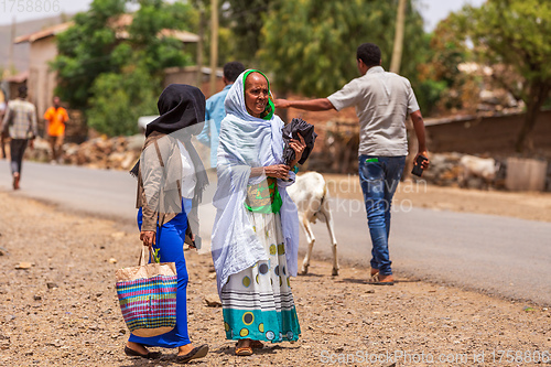 Image of tigray woman walking in center of of Aksum, Ethiopia Africa