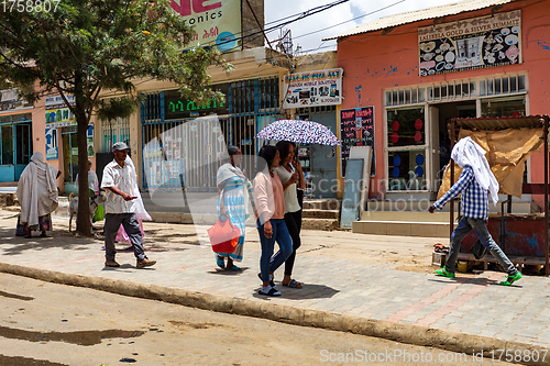 Image of tigray woman walking in center of of Aksum, Ethiopia Africa