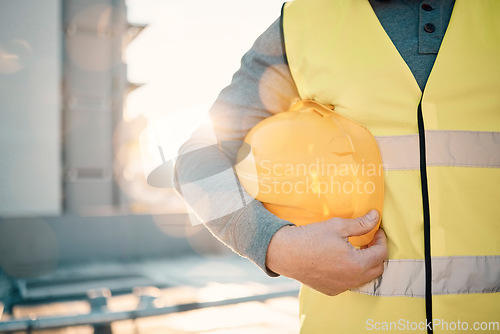 Image of Engineering, helmet and hands of construction worker in lens flare for urban development and architecture mission. Building contractor, builder person or technician with safety gear on city rooftop