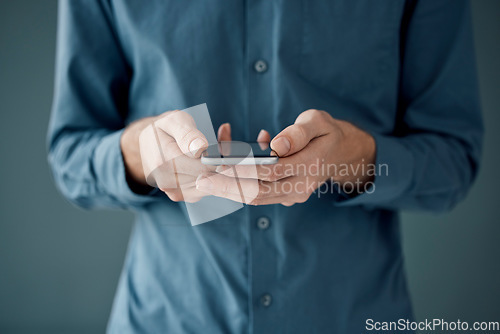 Image of Hands, phone and networking for social media, communication or digital marketing against a studio background. Hand of person holding mobile smartphone for online chatting, conversation or app