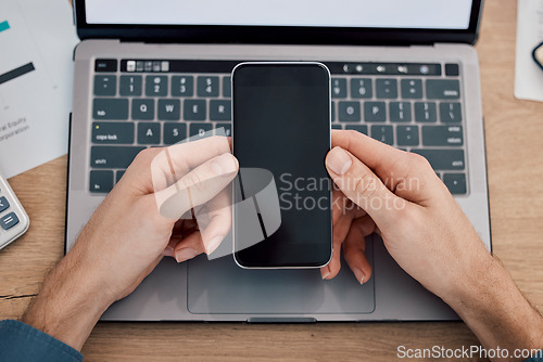 Image of Hands, phone and green screen by laptop on mockup for advertising, marketing or networking at office desk. Hand of person with mobile smartphone on mock up display by computer in advertisement or app