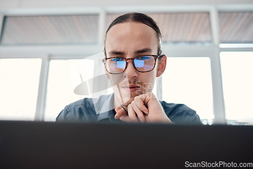 Image of Internet, laptop and serious businessman in office for email, typing and creative, web design and idea Website, search and seo man with glasses on online project, task and problem solving in London