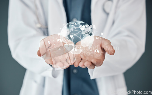 Image of Doctor, hands and 3D hologram of world for global healthcare, digital help or life insurance against a studio background. Hand of medical expert with futuristic globe for networking or innovation