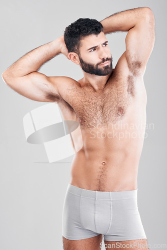 Image of Fitness, body and a man underwear model in studio on a gray background for health or grooming. Aesthetic, muscle and manly with a handsome young male posing to promote wellness or lifestyle