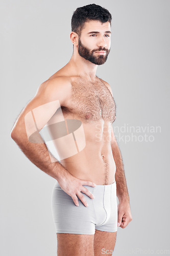 Image of Exercise, body and underwear with a man model in studio on a gray background for health or grooming. Aesthetic, muscle and manly with a handsome young male posing to promote wellness or lifestyle