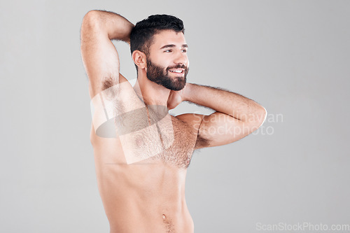 Image of Fitness, muscles and sexy man in a studio after a bodybuilding workout or sport training. Health, wellness and muscular male model flexing his biceps while posing isolated by a gray background.