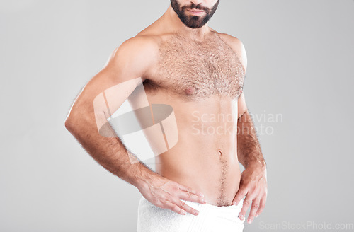 Image of Man, fitness body and towel in studio isolated on a gray background for sports health. Abs, training and bodybuilder with strong muscles after exercise, workout or bodybuilding for strength and power