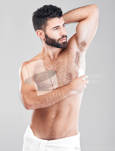 Image of Deodorant, roll and man grooming in studio for hygiene, fresh scent or underarm perfume. Male model, armpit and cosmetics for sweat control, body odor and cleaning product for skincare on background