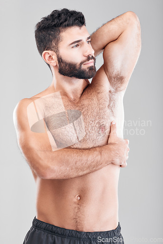 Image of Beauty, body and underarm with a man model in studio on a gray background for health or wellness. Skin, chest and muscle with a handsome young male standing indoor to promote a health lifestyle