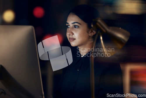 Image of Woman, night office and focus at computer for seo planning, research or agenda in dark startup. Female working overtime on desktop technology, online and network data of internet analytics on website