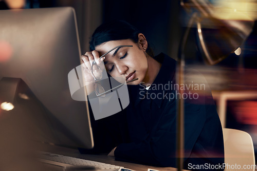 Image of Stress, tired and business woman at night working on computer for project, report and strategy deadline. Burnout, mental health and female worker in dark office frustrated, fatigued and overworked