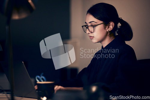 Image of Woman, night office and laptop for business, coding and strategy in dark startup company. Female working overtime online with technology on website, computer programmer and search internet analytics