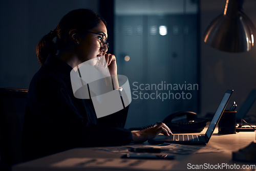 Image of Serious woman, night business and laptop for planning, research and strategy in dark startup office. Female working overtime on computer technology, online website and network at table for analytics