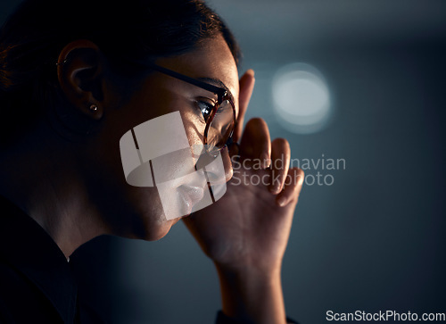 Image of Stress, night and face of business woman in office working on project, report and strategy deadline. Burnout, mental health and female worker in dark workplace with headache, frustrated and fatigue