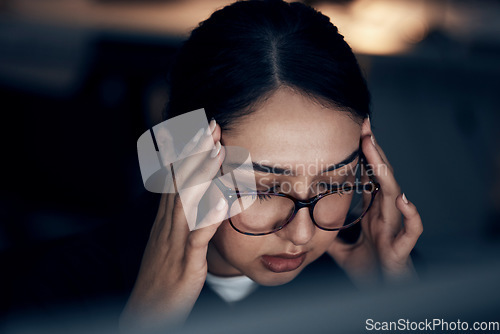 Image of Headache, stress and business woman at night working on computer for project, report and strategy deadline. Burnout, mental health and female worker in dark office frustrated, tired and overworked