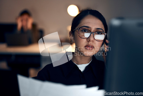 Image of Computer, night research or programmer woman for cybersecurity, app coding or data analysis in office. Thinking, developer or employee on tech for software code, documents or startup analytics review