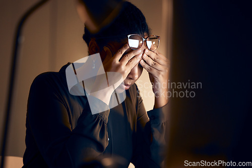 Image of Stress, burnout and business black woman at night working on project, report and strategy deadline. Headache, mental health and female in dark office frustrated, tired and work problem on computer