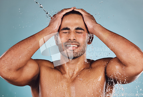 Image of Man, water splash and face wash for skincare hygiene, hydration or shower against studio background. Young male model in beauty, wellness and washing or cleansing for clean facial body care treatment