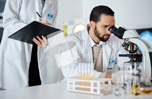 Image of Scientist, woman and man by microscope with checklist in laboratory for research at pharma company. Science team, data analytics and biotechnology for goals, vision and study virus for lab innovation