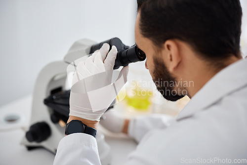 Image of Microscope, medical and research with a man at work in a laboratory for science, innovation or development. Doctor, analytics and biotechnology with a male scientist working in a lab for breakthrough