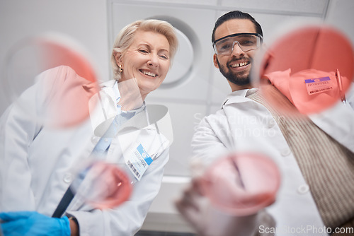 Image of Research, DNA and science by scientists in analytics with sample in lab smile and happy for results. Professional, expert and medical technician in a laboratory as teamwork, team and collaboration