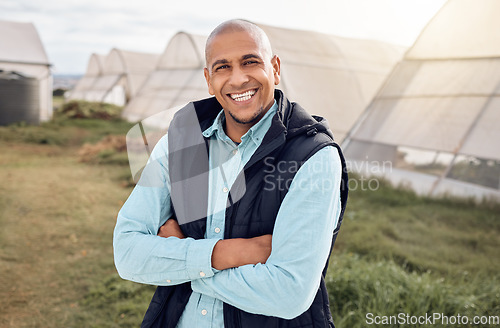 Image of Black man, farmer and outdoor portrait with arms crossed, smile and happiness for sustainable farm. Farming expert, sustainability and happy in field by greenhouse with goals, vision and motivation
