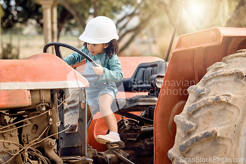 Image of Girl child in tractor, agriculture and farming transport, sustainability and learning field work with development and fun. Childhood, farm machinery and farmer in training with growth and young kid