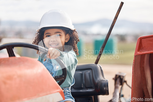 Image of Girl child in tractor, portrait and farming transport, sustainability and learning field work with development and fun. Childhood, farm machinery and farmer in training, growth and kid in agriculture