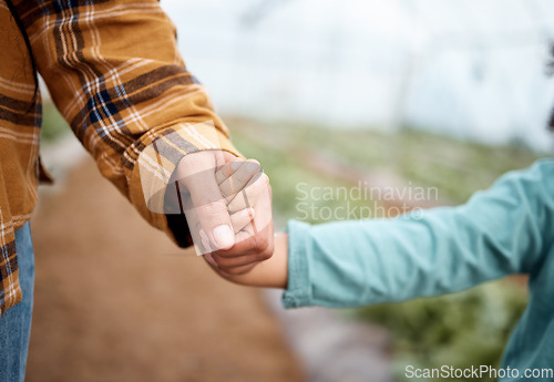 Image of Holding hands, family and children on a farm for agriculture or sustainability in a greenhouse for crop growth. Hand, love or kids with a mother and daughter walking together in the countryside