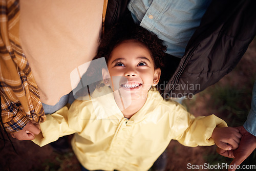 Image of Above, holding hands and face of a girl with parents for love, support and care in nature. Happy, fun and playful child with mother, father and affection in the countryside of Australia for bonding